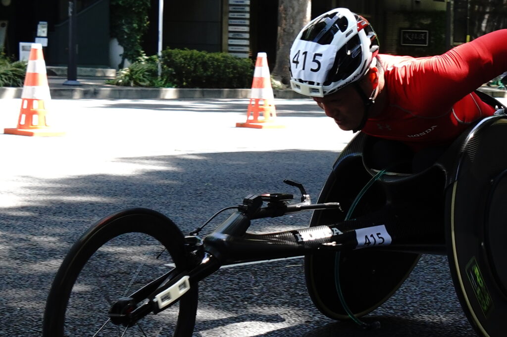 猛スピードで駆け抜けて行く車イスの選手
